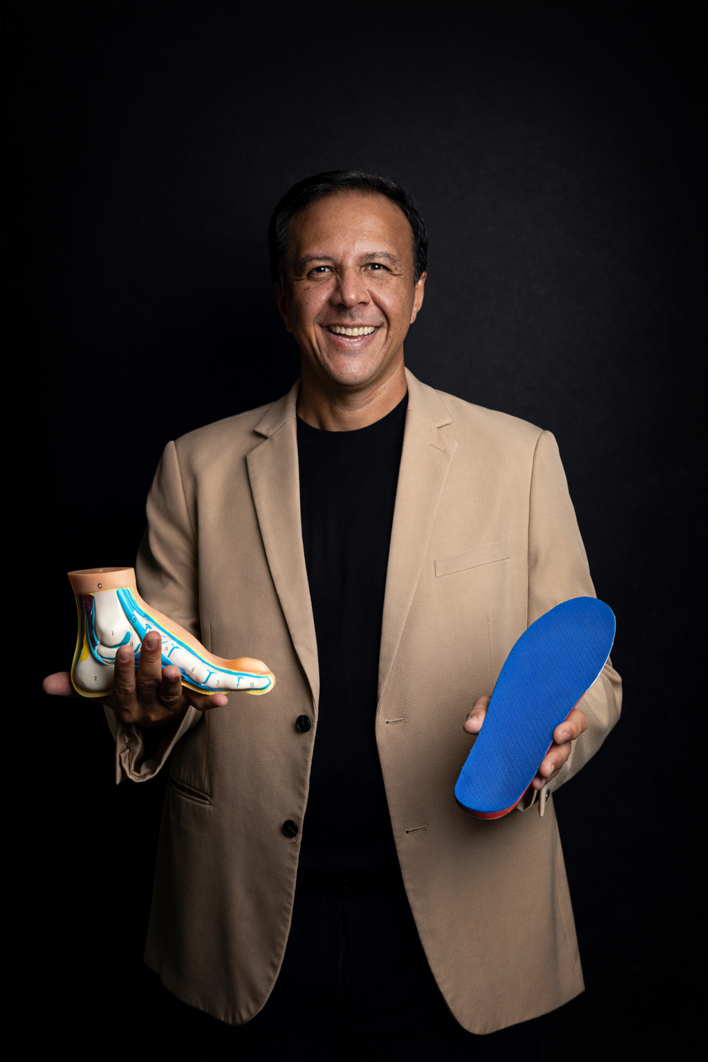 Prof. Me. Rafael Temoteo segurando modelo anatômico do pé e palmilha